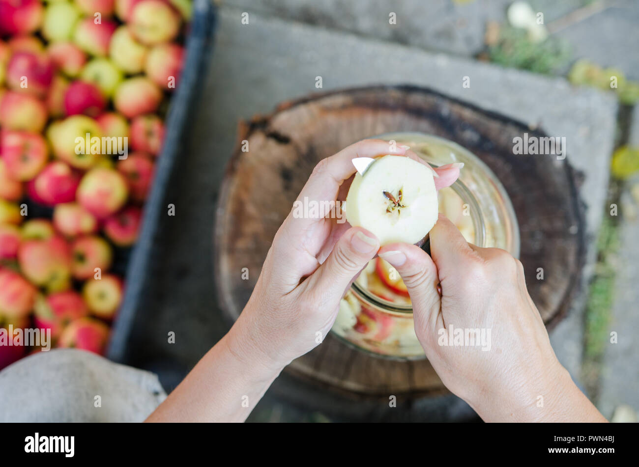 Making of apple vinegar - scene from above - hand peeling apples Stock Photo