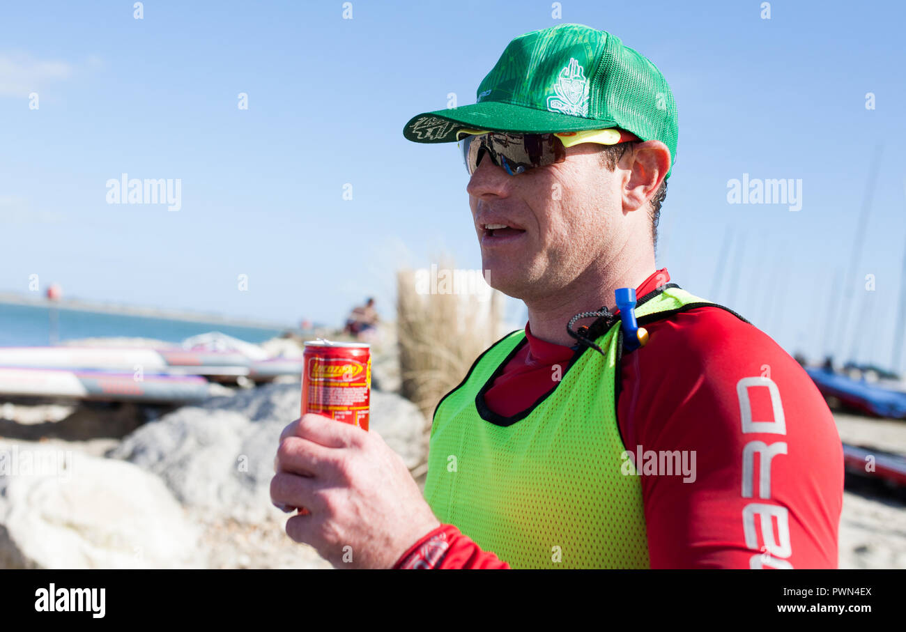 Man winning paddle board race and explaining the trip Stock Photo