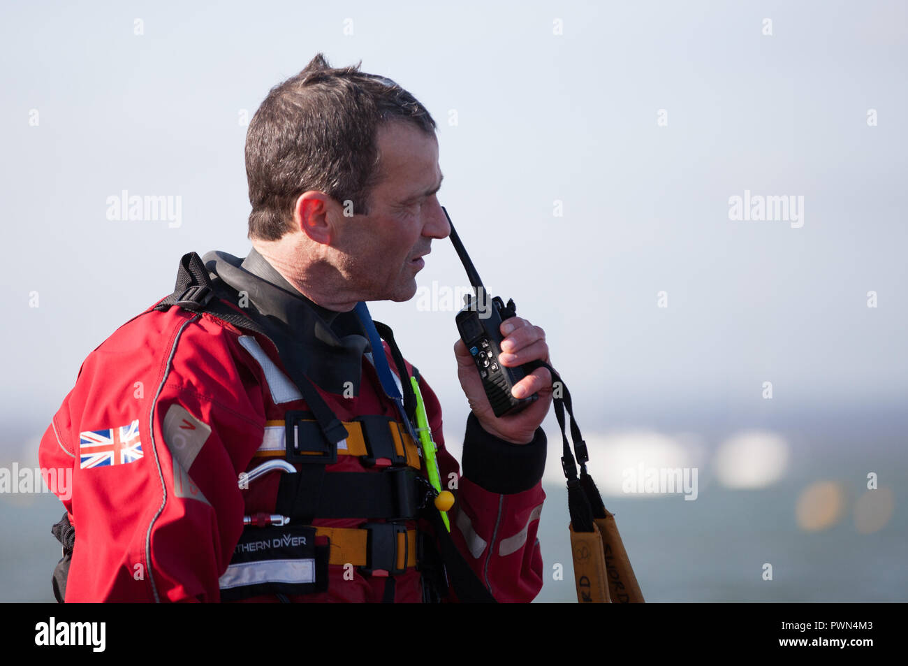 Coast Guard worker on the radio reporting Stock Photo