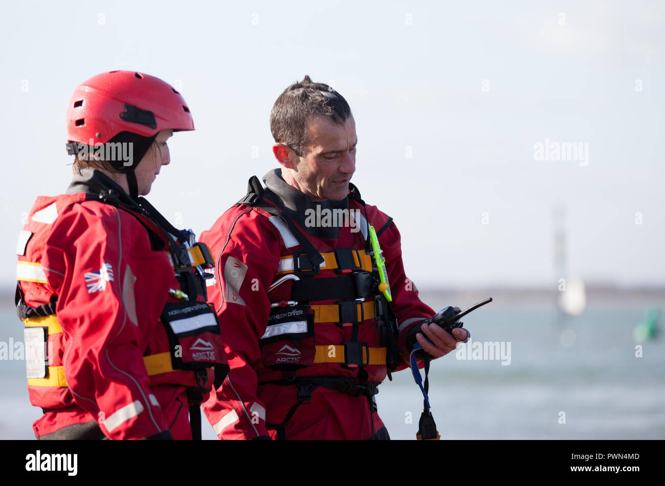 Two coast guards standing discussing work Stock Photo