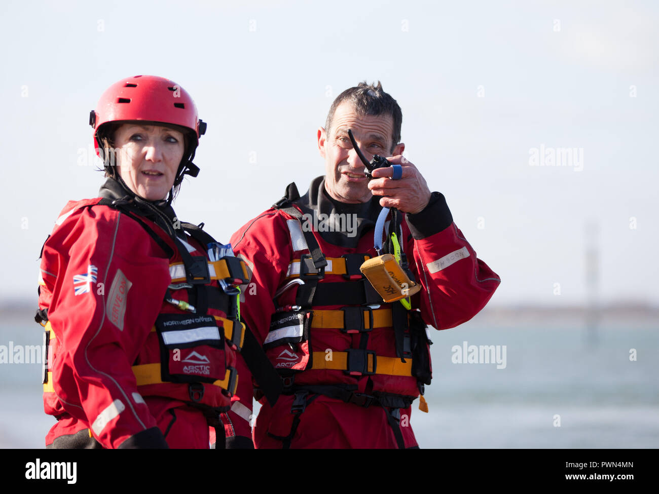 Two coast guards standing discussing work Stock Photo