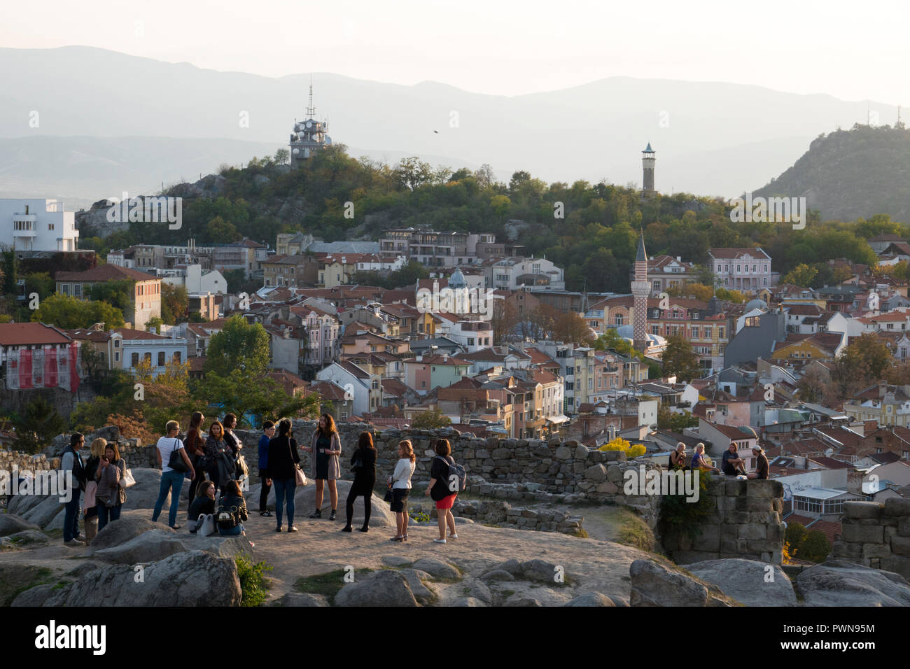 Guided group of tourists on scenic lookout over old town Plovdiv, Bulgaria Stock Photo
