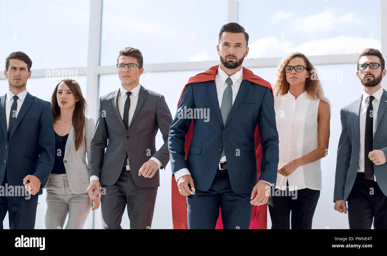 businessman in a red superhero cloak and his business team Stock Photo ...