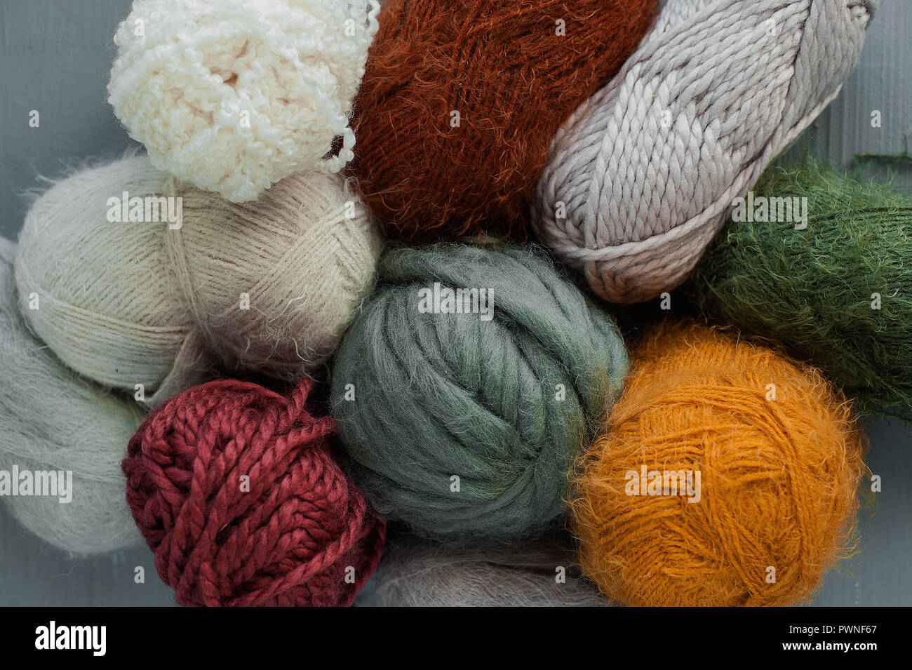 Variety of knitting yarns on grey background. Top view Stock Photo