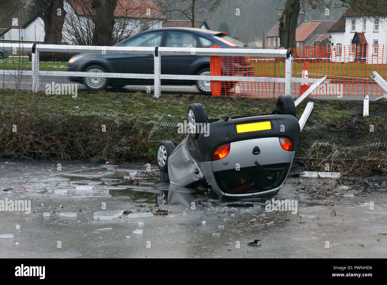 road traffic collision, car crash into pond, black ice Stock Photo