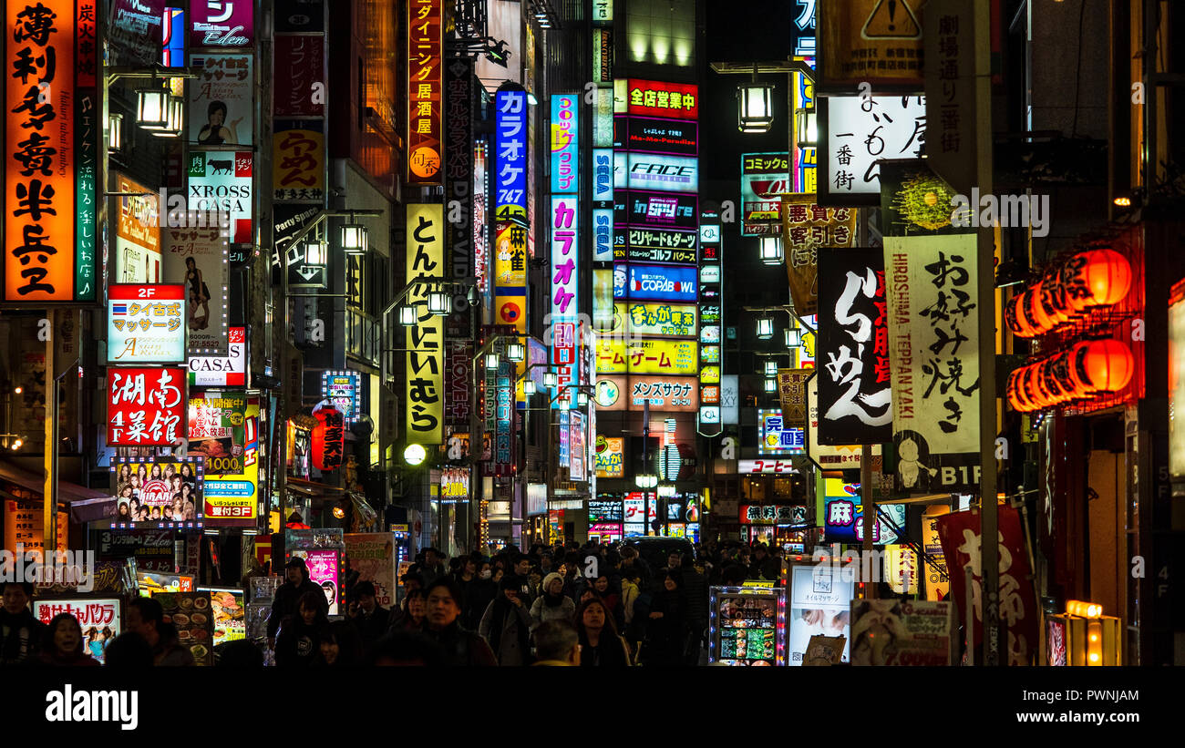 Tokyo Nightlife - the Shinjuku Kabukicho entertainment and red-light district is full of bright lights and neon lit signs at night. Stock Photo