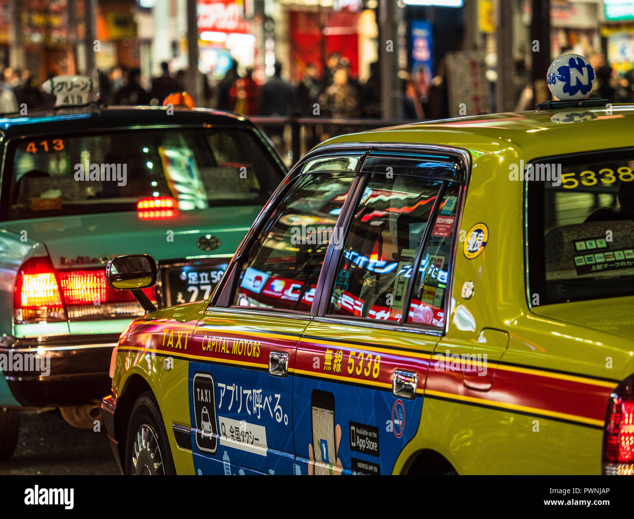 Tokyo Taxis Taxi Tokyo Nightlife - vibrant lights reflect off Tokyo taxis  in the Shinjuku district Stock Photo