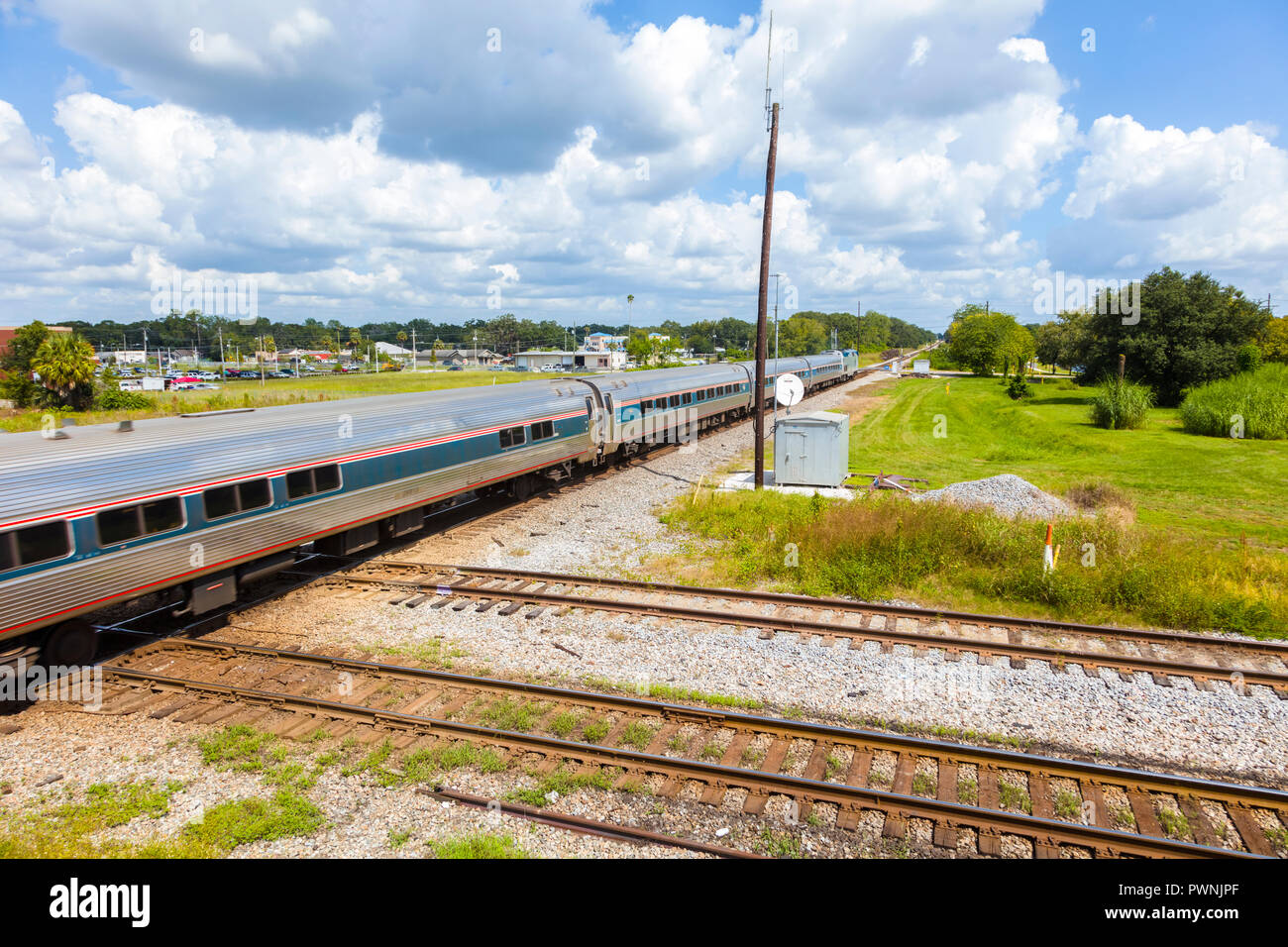 Passenger train on tracks at track intersection at the Union Station Depot and Train Veiwing Platform in Plant City Florida in the United States Stock Photo