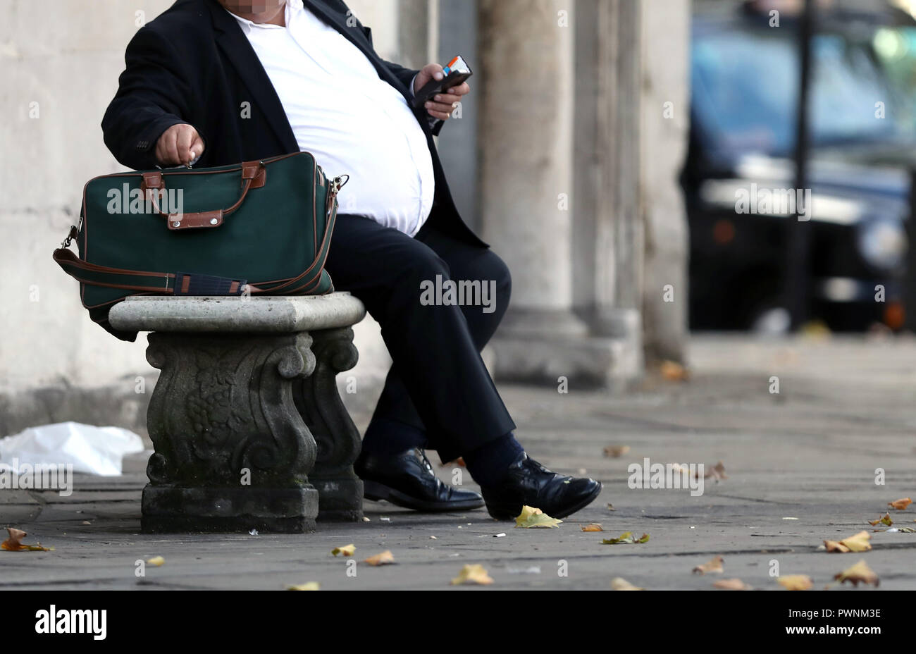 Pic shows: Obese man sitting on a bench    pic by Gavin Rodgers/Pixel8000 Stock Photo