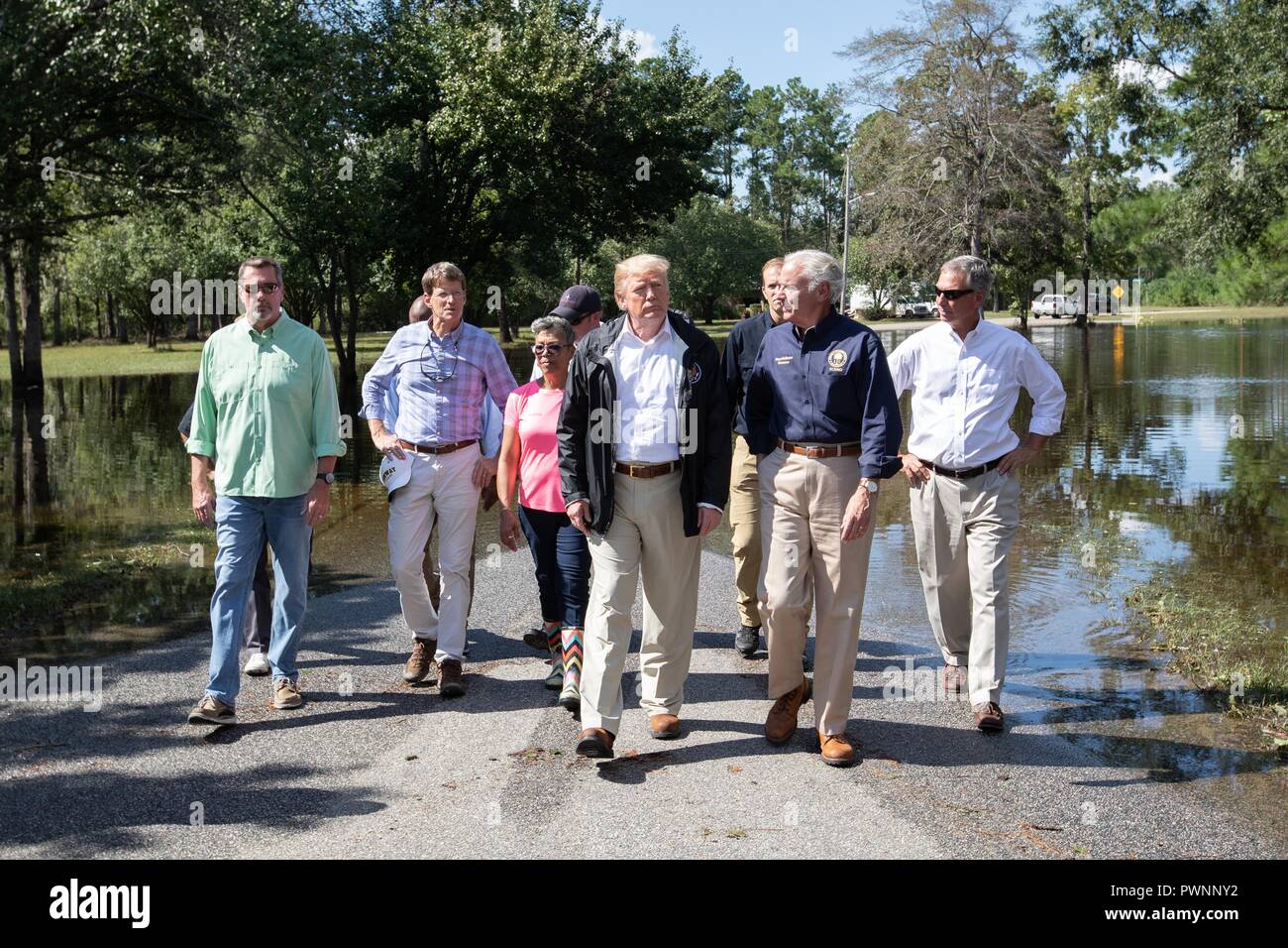 U.S President Donald Trump, center, walks with South Carolina Governor Henry McMaster, right, during a visit to view flooding caused by Hurricane Florence September 19, 2018 in Conway, South Carolina. Florence dumped record amounts of rainfall along the North & South Carolina coast causing widespread flooding. Stock Photo