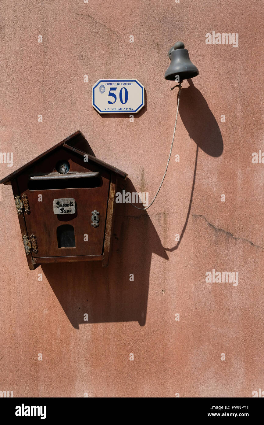 Wood mailbox on pink wall in Santa Lucia, Tuscany, Italy. Stock Photo