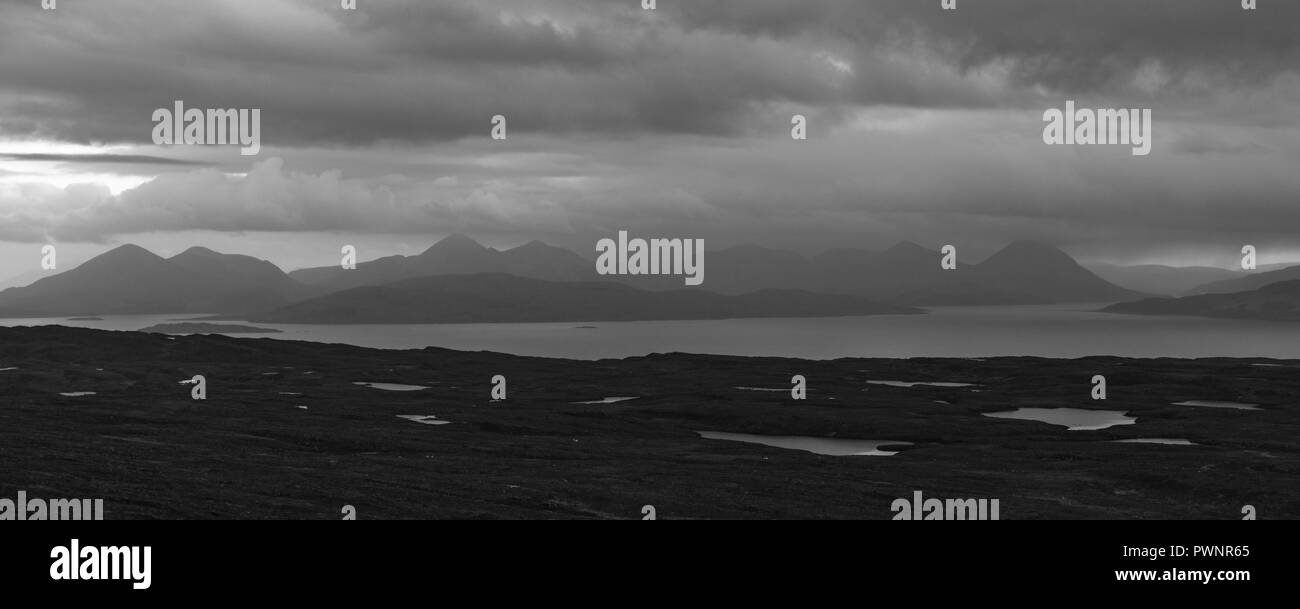 Black and white panoramo of the isle of skye with lakes and the sea in the foreground. Belach na Ba Viepoint. Scotland Stock Photo