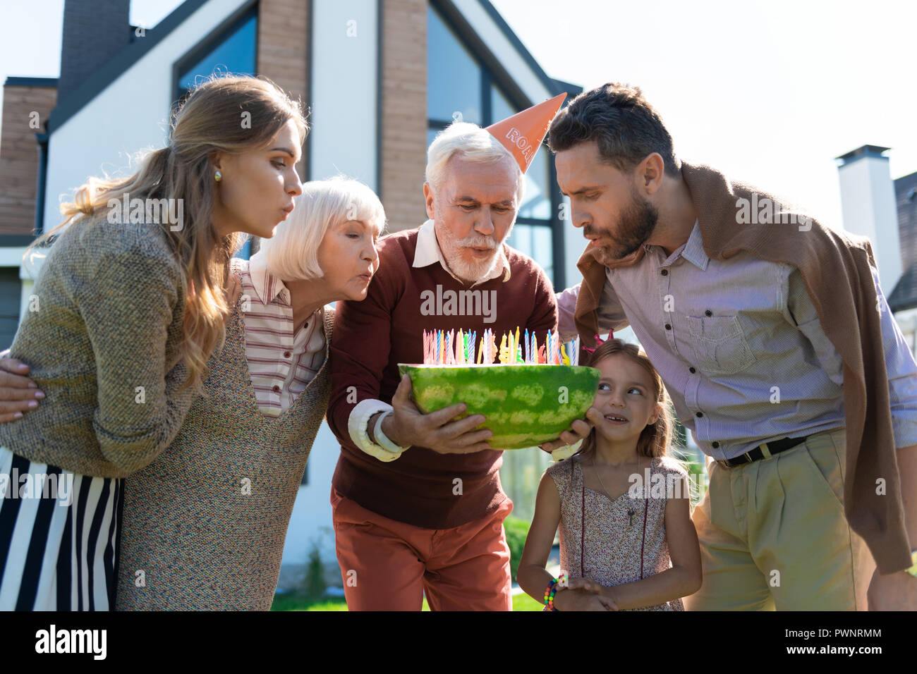Happy mature man celebrating his birthday with family Stock Photo