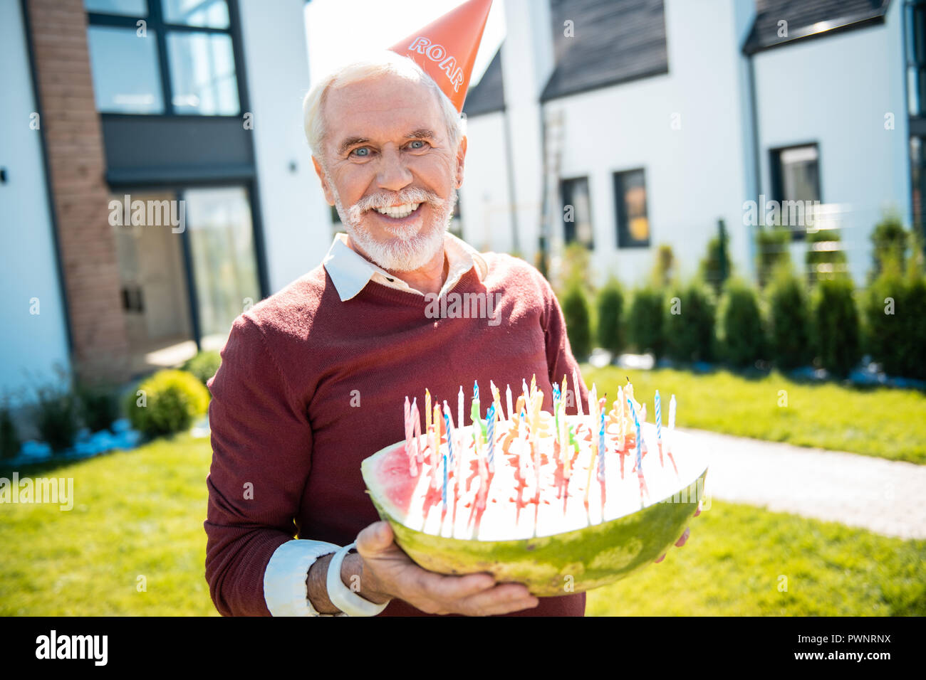 Positive delighted senior male person poising on camera Stock Photo