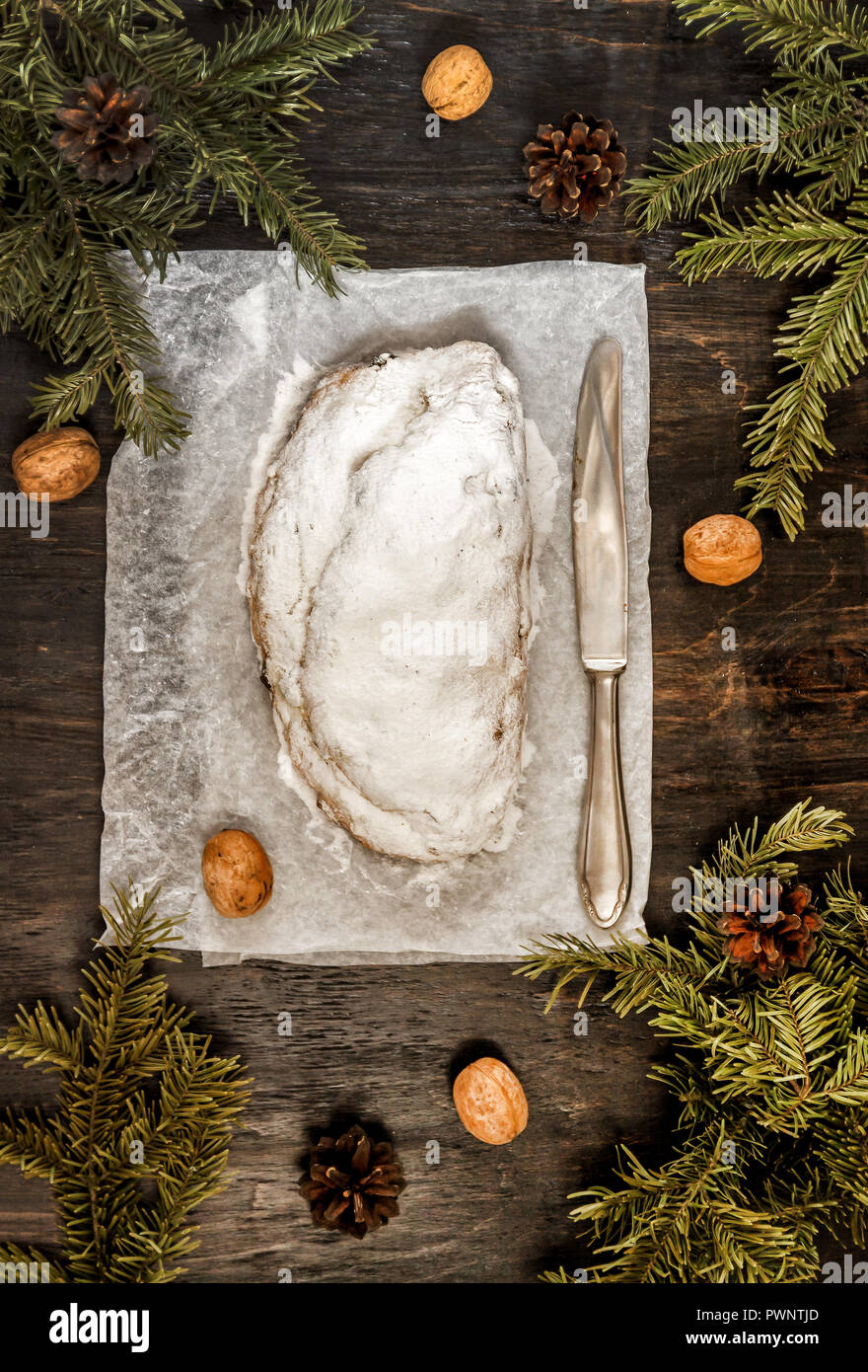 Traditional German Christmas fruit cake stollen on a dark background