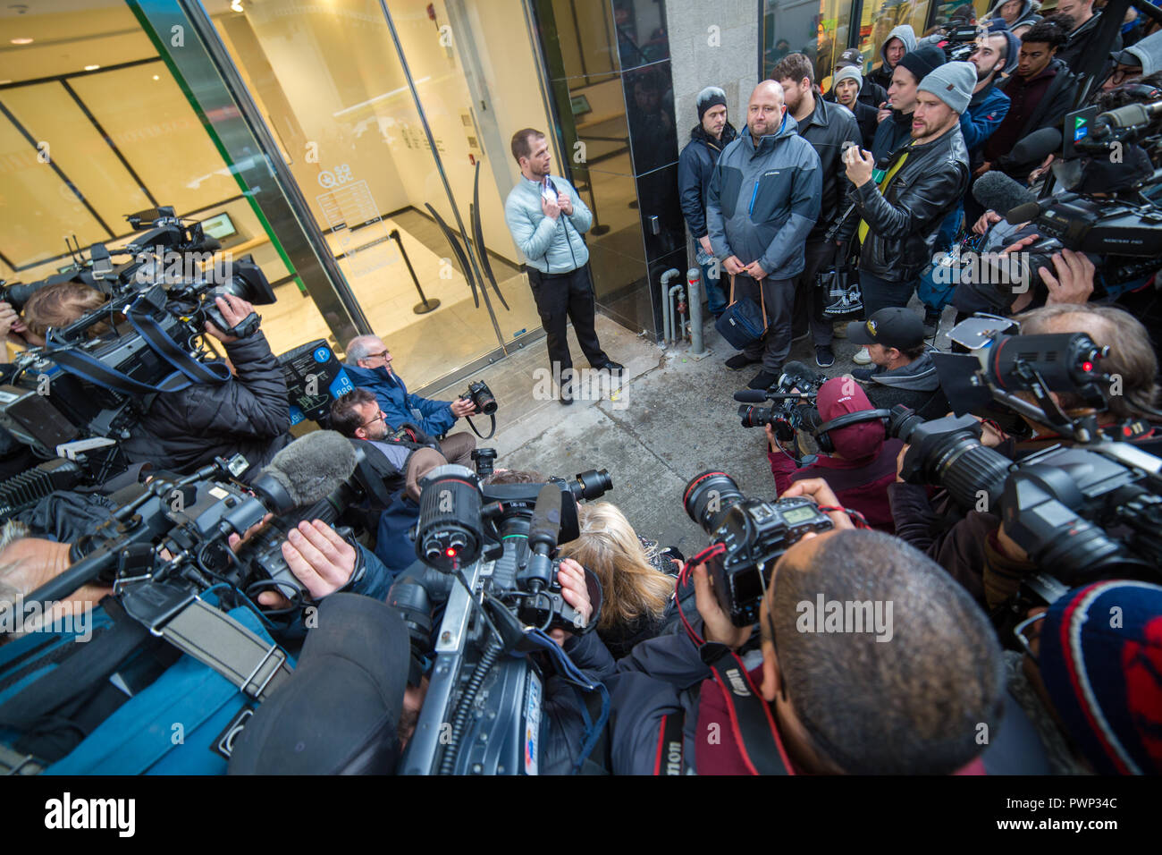 Montreal, Canada. 17th Oct, 2018. Members of the media are waiting for the doors to open at the SQDC (Société québécoise du cannabis) store. Hugo Senecal, a 39-year-old Montrealer who was at the head of that line on Sainte Catherine street, waited since 3:30 am to be the first to buy legal marijuana at that store. Cannabis became legal in Canada on October 17. In Quebec, it will be commercialized by the SQDC. Credit: Cristian Mijea/Alamy Live News Stock Photo