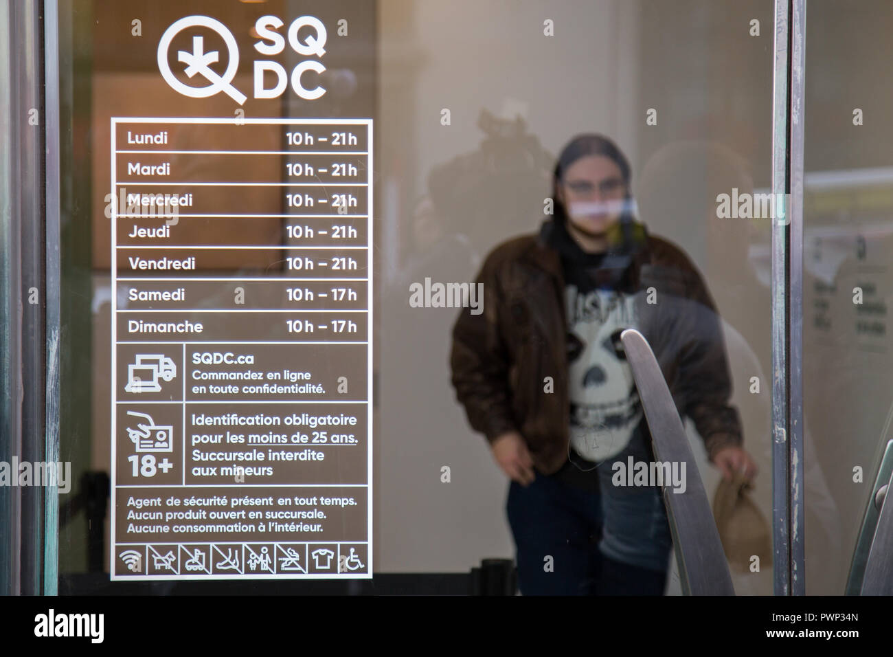 Montreal, Canada. 17th Oct, 2018. A Montrealer is seen through the doors of the Montreal's Sainte Catherine street SQDC store on the first day after the legalization of cannabis in Canada. Credit: Cristian Mijea/Alamy Live News Stock Photo