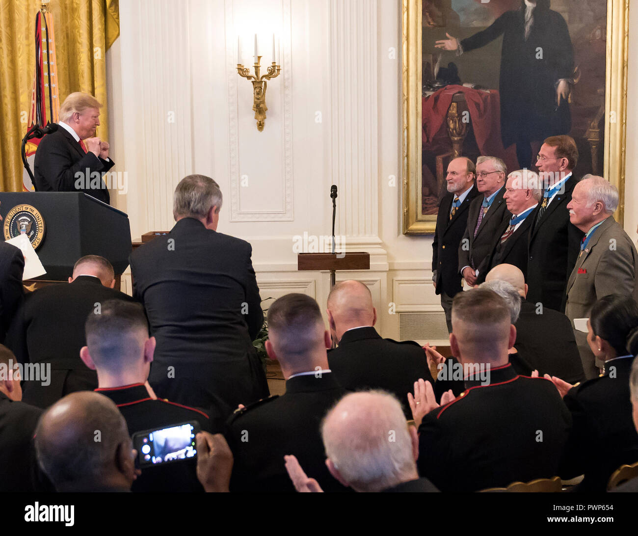 United States President Donald J. Trump acknowledges previous recipients during the ceremony where he will award the Medal of Honor to Sergeant Major John L. Canley, United States Marine Corps (Retired), for conspicuous gallantry during the Vietnam War in a ceremony in the East Room of the the White House in Washington, DC on Wednesday, October 17, 2018. Credit: Ron Sachs/CNP | usage worldwide Stock Photo