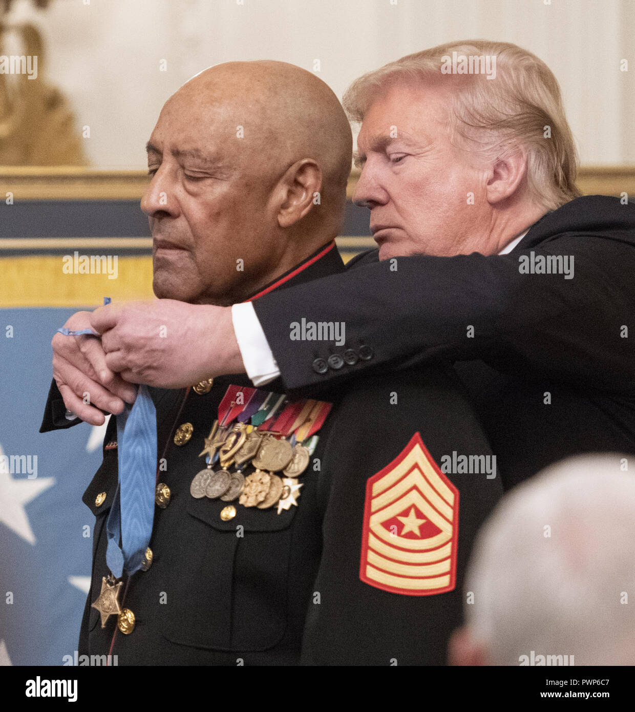 Washington, District of Columbia, USA. 17th Oct, 2018. United States President Donald J. Trump awards the Medal of Honor to Sergeant Major John L. Canley, United States Marine Corps (Retired), for conspicuous gallantry during the Vietnam War in a ceremony in the East Room of the the White House in Washington, DC on Wednesday, October 17, 2018 Credit: Ron Sachs/CNP/ZUMA Wire/Alamy Live News Stock Photo