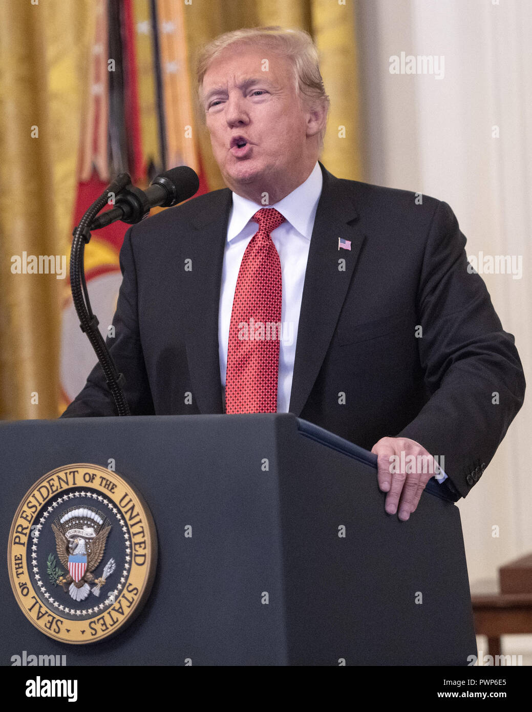 Washington, District of Columbia, USA. 17th Oct, 2018. United States President Donald J. Trump makes remarks as he awards the Medal of Honor to Sergeant Major John L. Canley, United States Marine Corps (Retired), for conspicuous gallantry during the Vietnam War in a ceremony in the East Room of the the White House in Washington, DC on Wednesday, October 17, 2018 Credit: Ron Sachs/CNP/ZUMA Wire/Alamy Live News Stock Photo