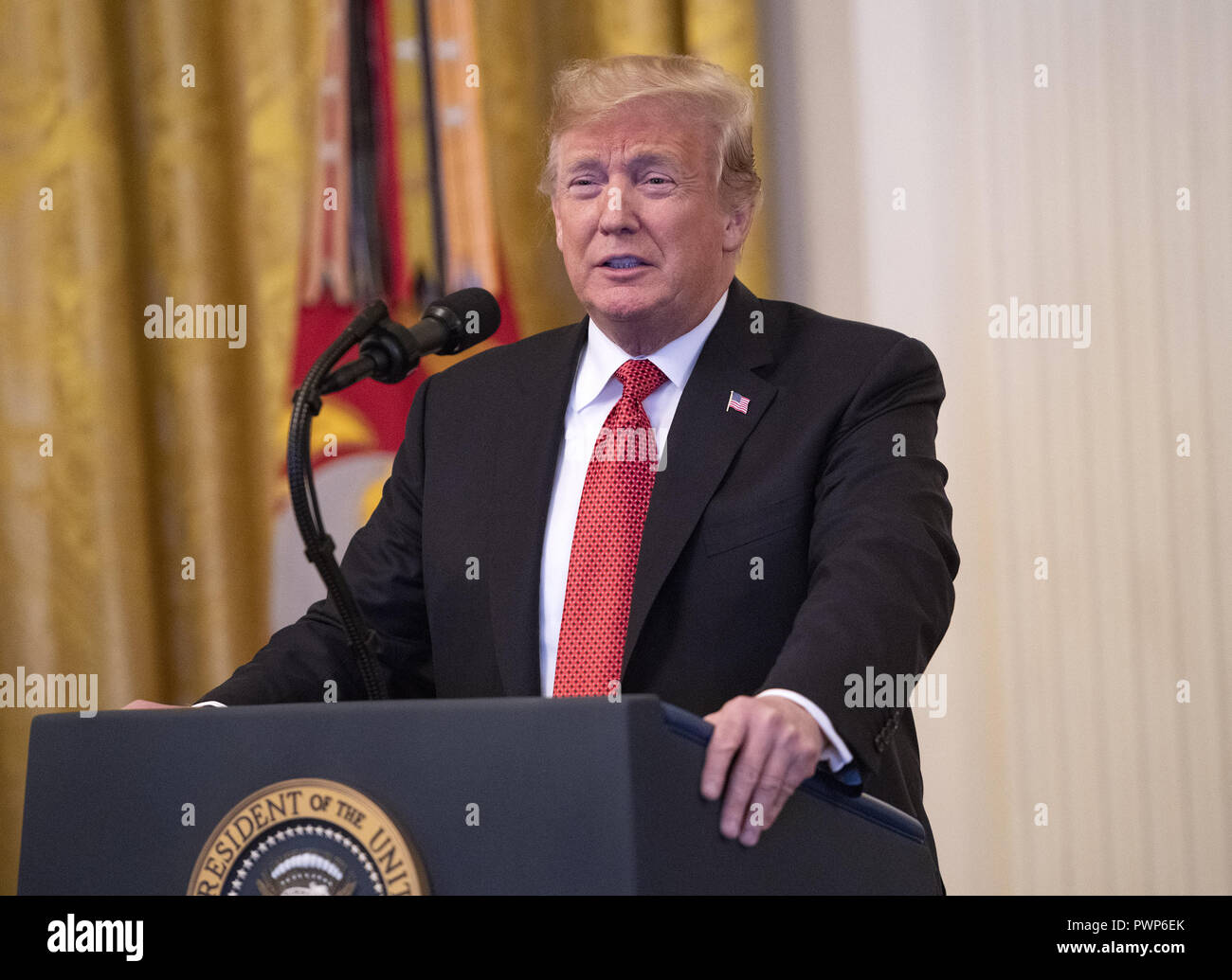 Washington, District of Columbia, USA. 17th Oct, 2018. United States President Donald J. Trump makes remarks as he awards the Medal of Honor to Sergeant Major John L. Canley, United States Marine Corps (Retired), for conspicuous gallantry during the Vietnam War in a ceremony in the East Room of the the White House in Washington, DC on Wednesday, October 17, 2018 Credit: Ron Sachs/CNP/ZUMA Wire/Alamy Live News Stock Photo