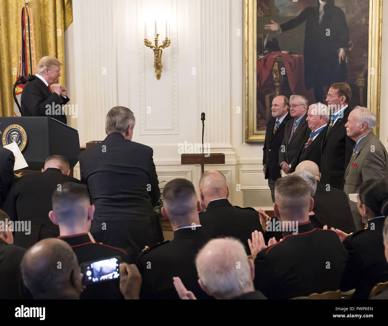 Washington, District of Columbia, USA. 17th Oct, 2018. United States President Donald J. Trump acknowledges previous recipients during the ceremony where he will award the Medal of Honor to Sergeant Major John L. Canley, United States Marine Corps (Retired), for conspicuous gallantry during the Vietnam War in a ceremony in the East Room of the the White House in Washington, DC on Wednesday, October 17, 2018 Credit: Ron Sachs/CNP/ZUMA Wire/Alamy Live News Stock Photo