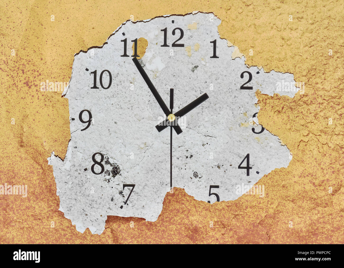 Big clock on a yellow peeling wall showing the time Stock Photo - Alamy