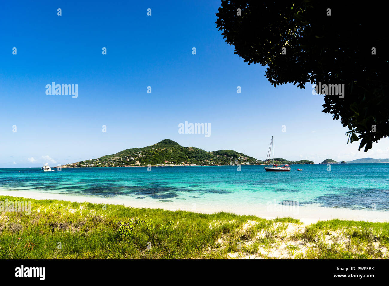 View on Petite-Martinique's island and a boat, Saint Vincent and the Grenadines, Lesser Antilles, West Indies, Windward Islands, Caribbean, Central America Stock Photo