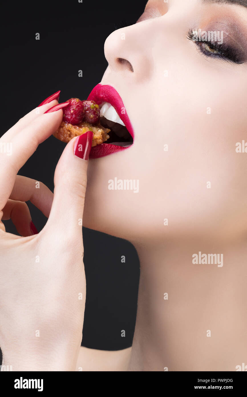Tight shot of girl tasting red fruit tart Stock Photo