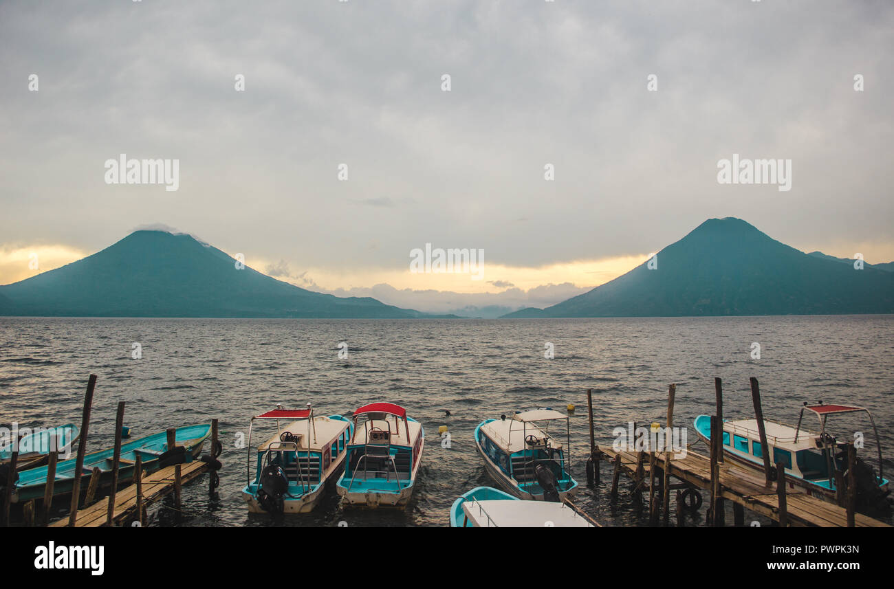 Sunset from the water taxi docks of San Juan La Laguna, with views of the mountains and volcano of Lake Atitlán, Guatemala Stock Photo
