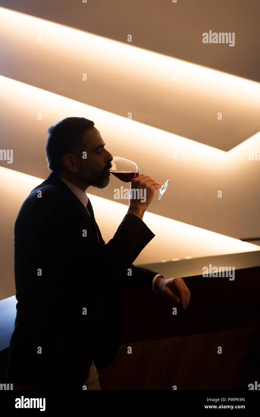 Portrait of senior handsome man drinking red wine Stock Photo - Alamy