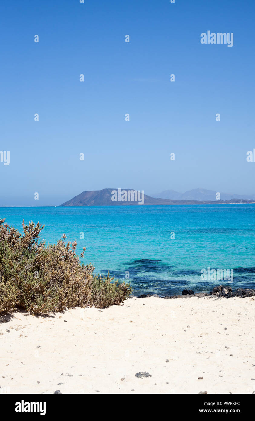 The tiny Island of Los Lobos and Lanzarote in the distance seen from Las Grandes Playas, Fuerteventura, Canary Islands, Spain Stock Photo