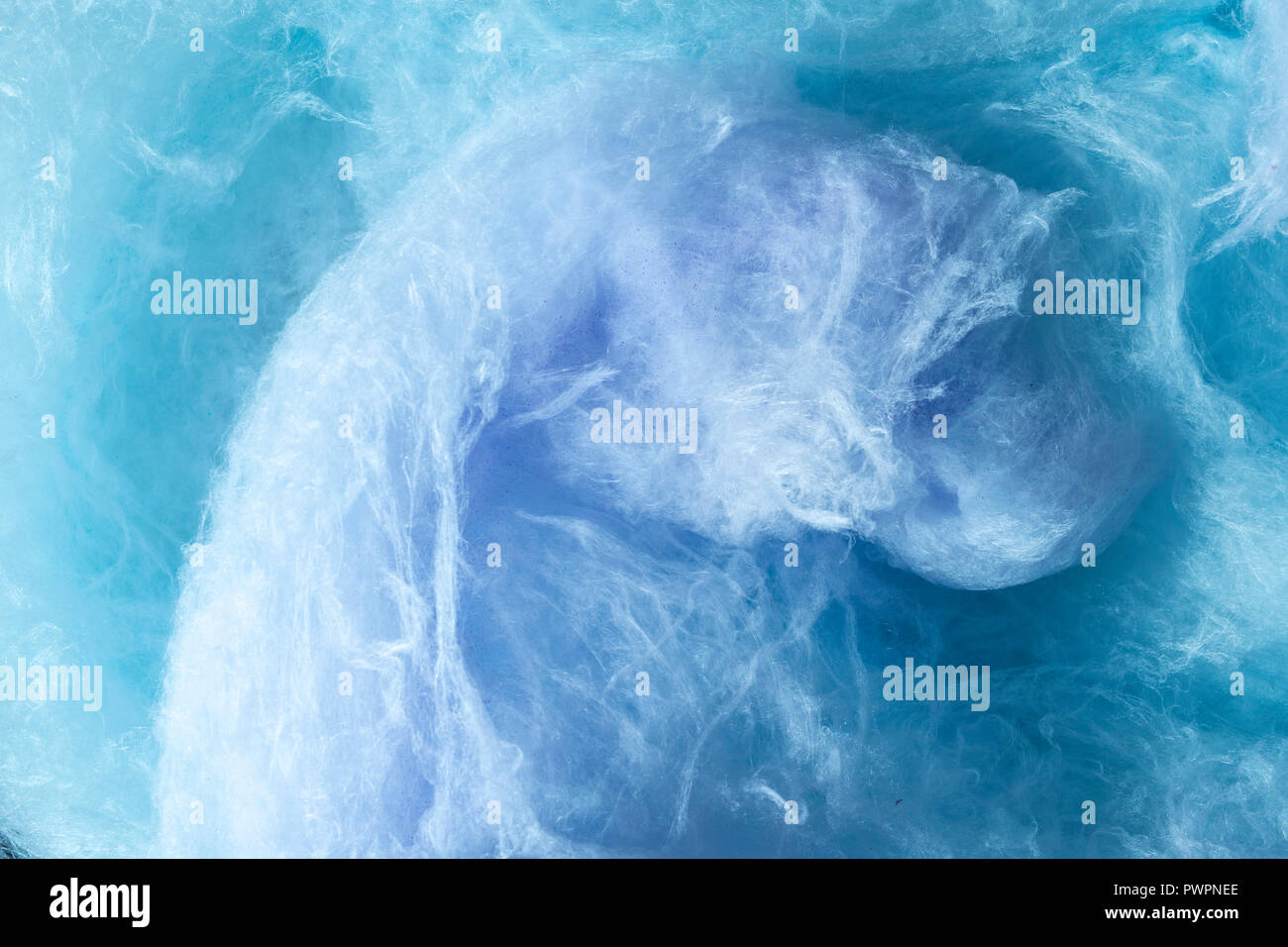 Giant swirl of purple and blue cotton candy filling frame. Stock Photo
