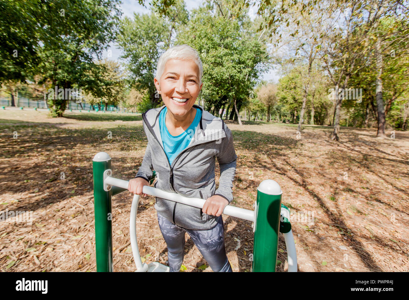 Healthy Mature Woman Workout At Outdoor Gym In Forest Sporty