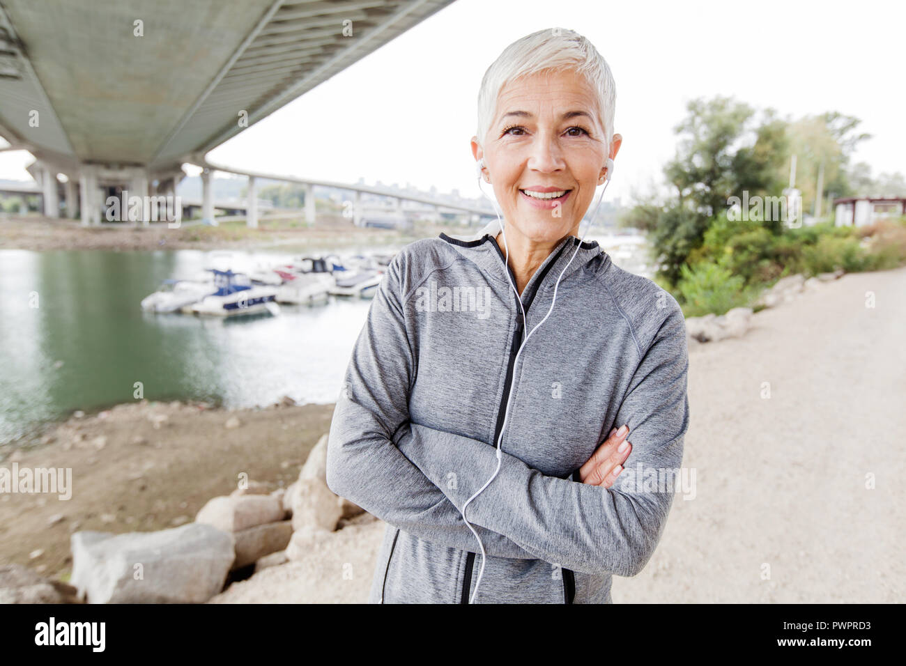 Smiling Senior Woman Relax Listening Music With Earphones After