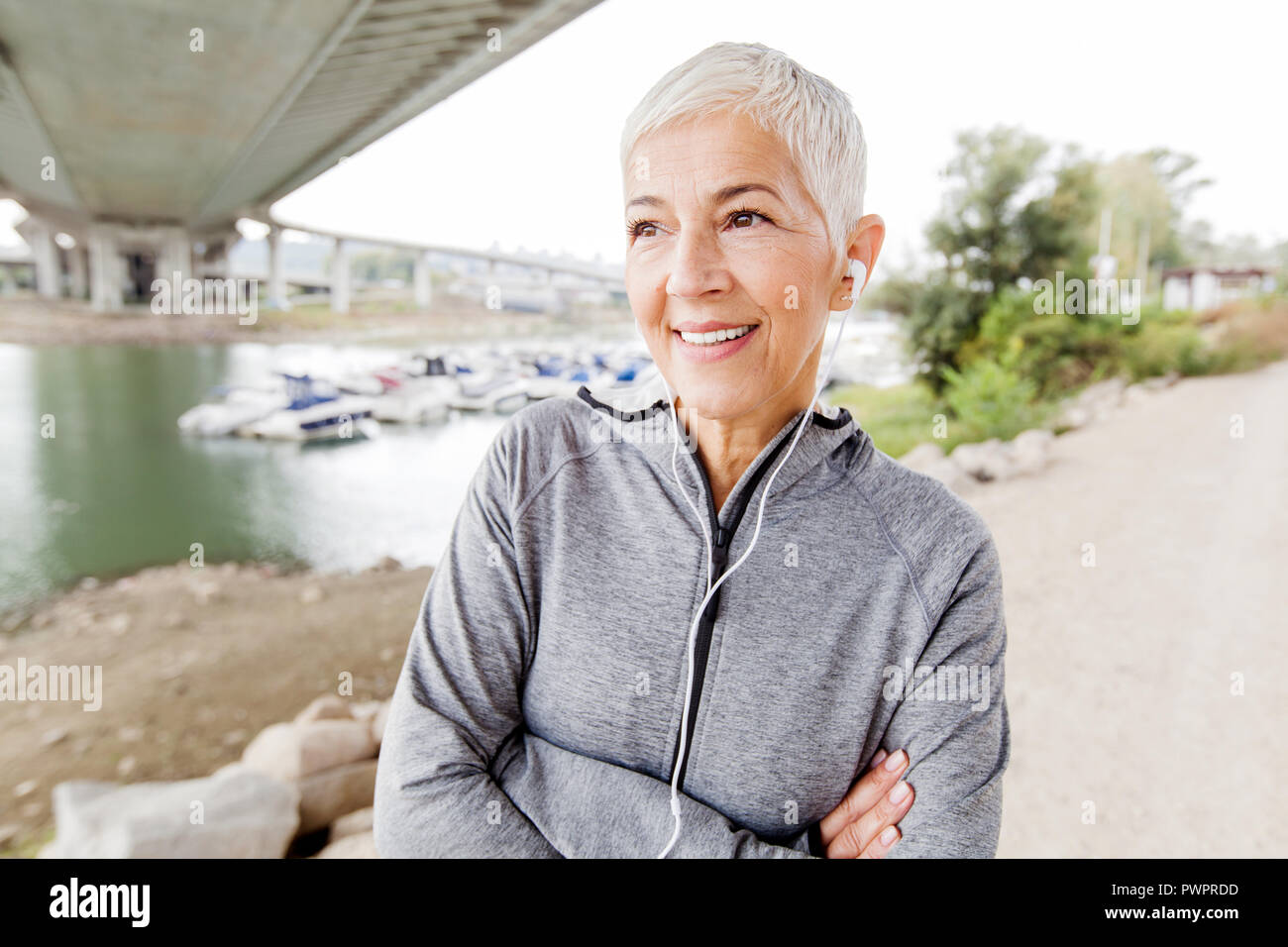 Smiling Senior Woman Relax Listening Music With Earphones After
