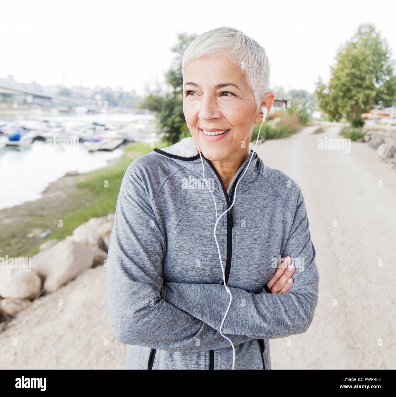 Smiling Senior Woman Relaxing Listening Music With Earphones After