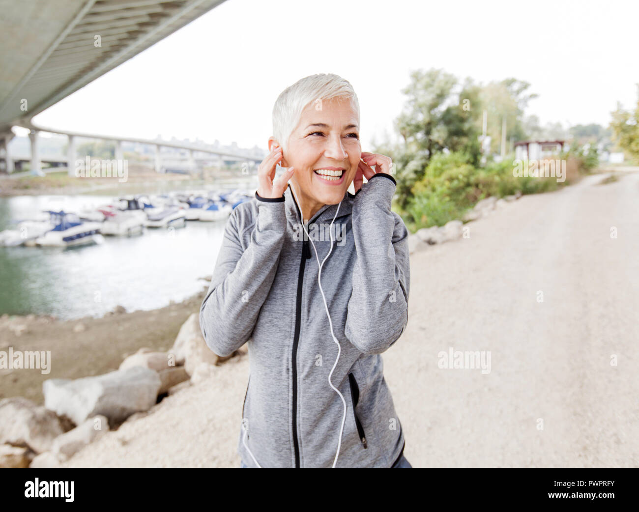 Happy Mature Woman Relax Listening Music With Earphones After