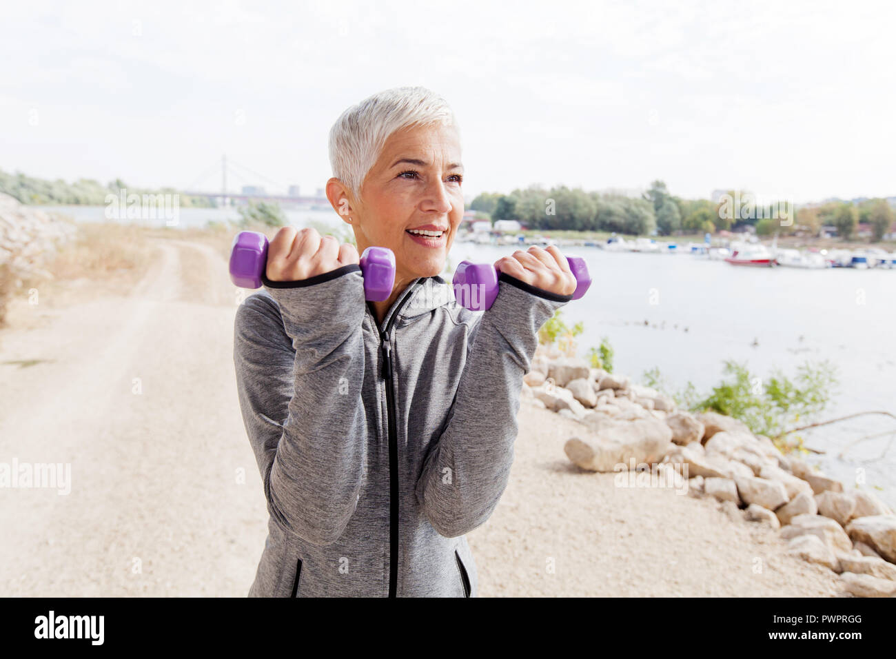 Healthy Mature Woman Exercise With Weights Gray Short Hair