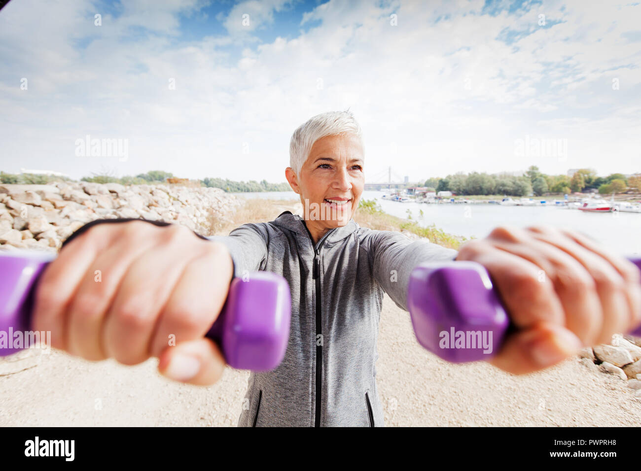 Healthy Mature Woman Exercise With Weights Gray Short Hair