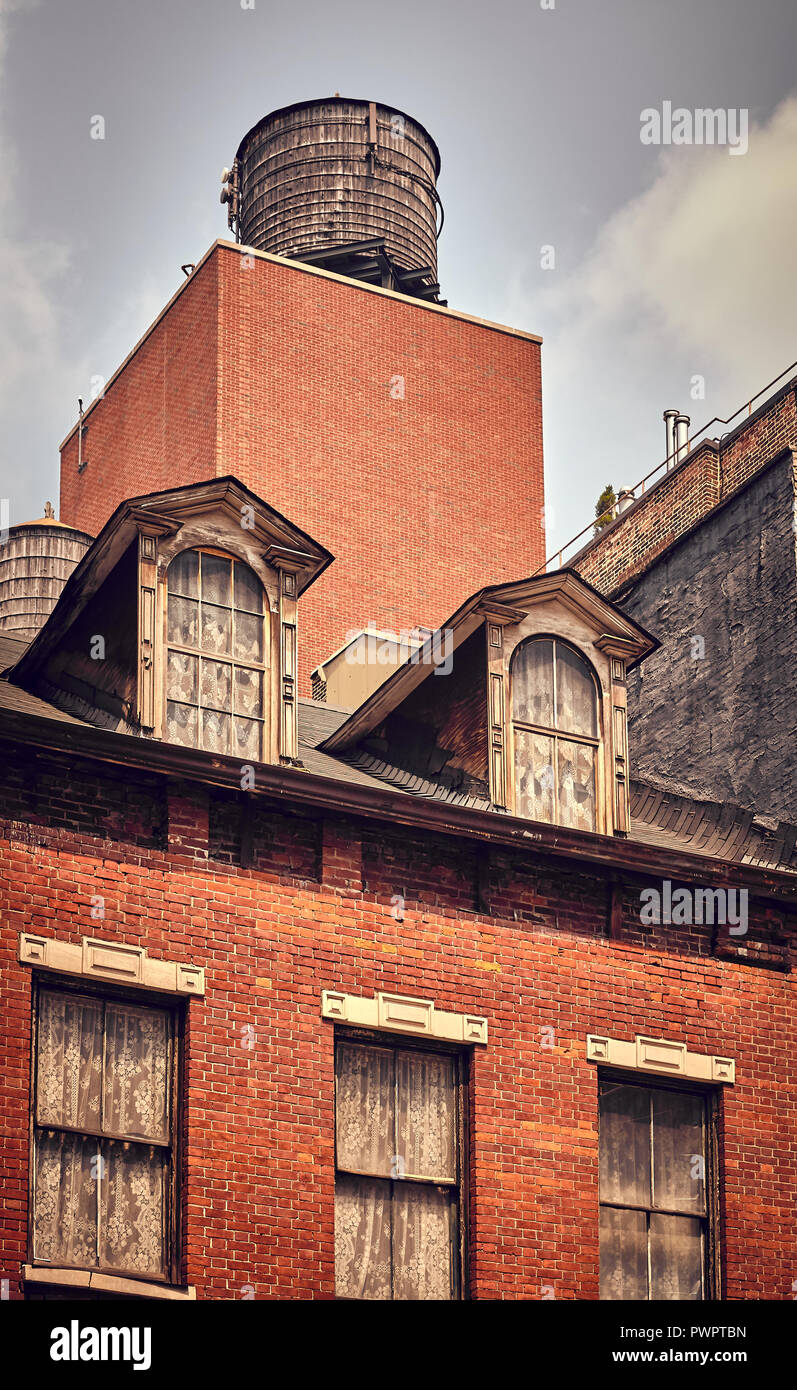 Vintage toned picture of water tank on roof of an old building, New York City, USA. Stock Photo