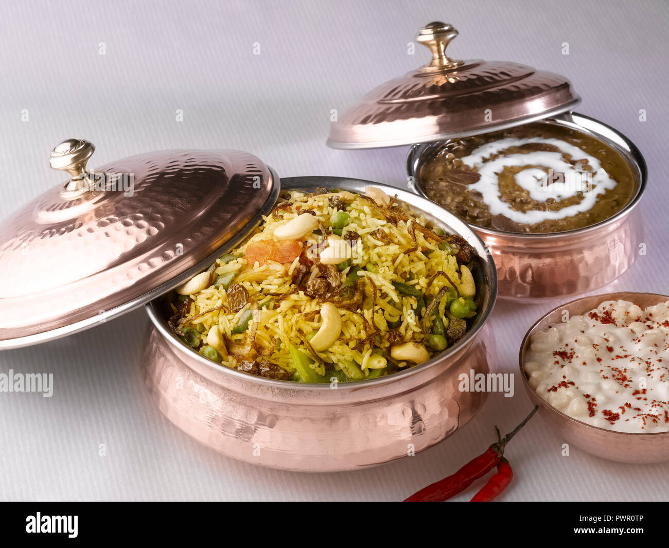 BIRYANI & DAL MAKHANI SERVED IN A COPPER HANDI WITH BUNDI RAITA Stock ...