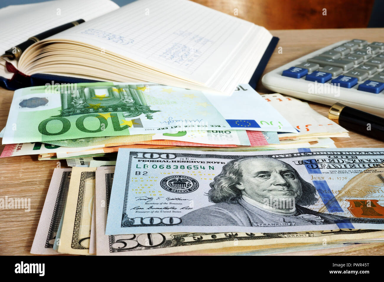 Exchange rate. Stacks of Euros and dollars on accountant desk. Stock Photo