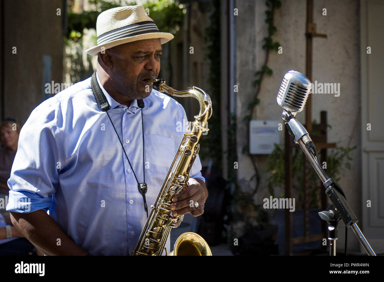 Musician playing saxophon on street in French village Stock Photo