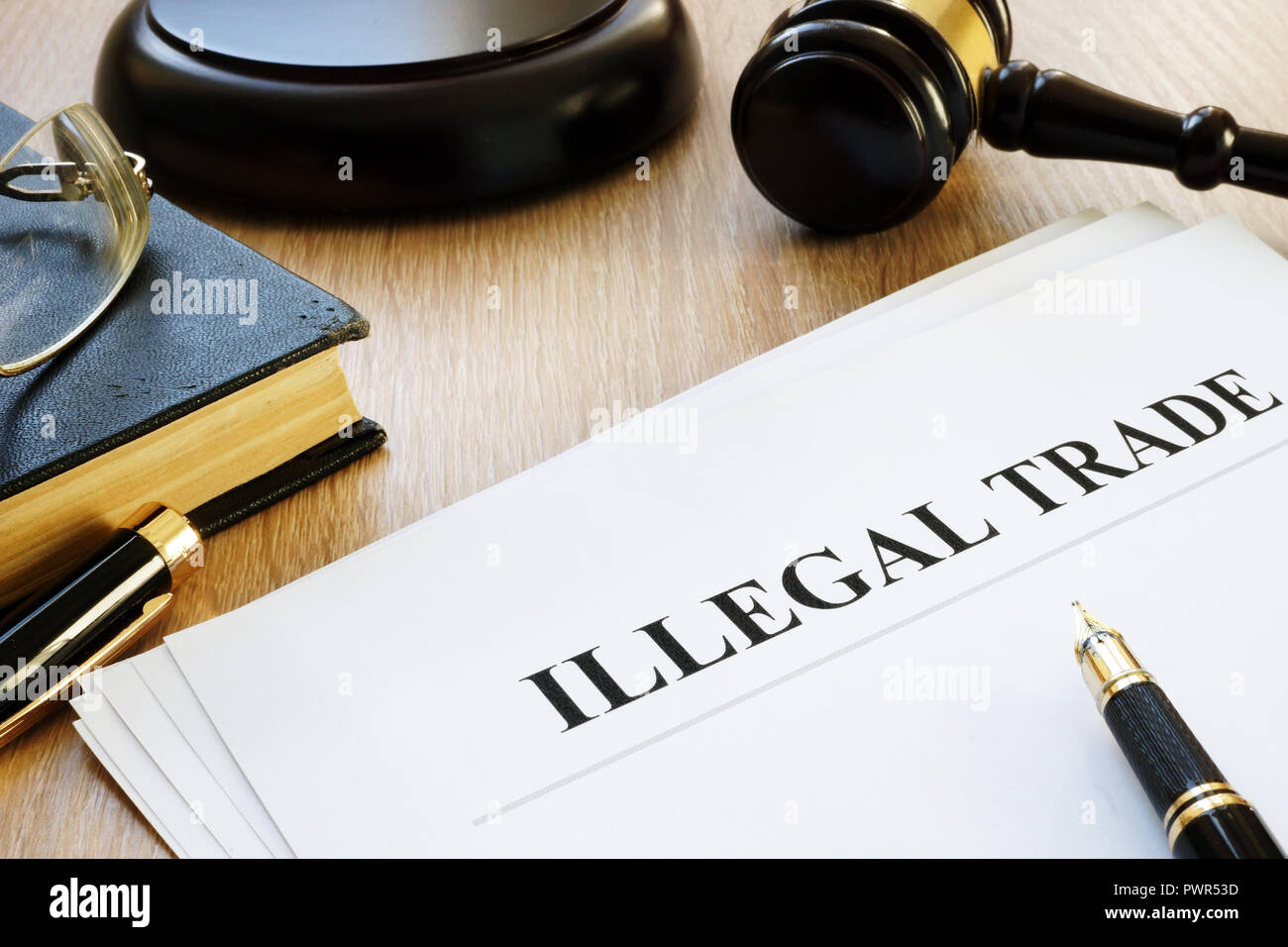 Illegal trade report, pen and gavel. Stock Photo