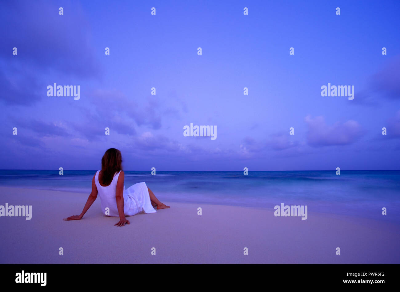 Woman relaxing on beach in Mexico Stock Photo