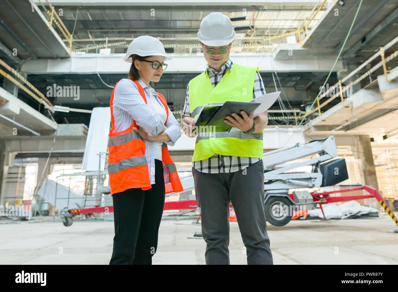 Group of engineers, builders, architects on the building site. Construction, development, teamwork and people concept. Stock Photo
