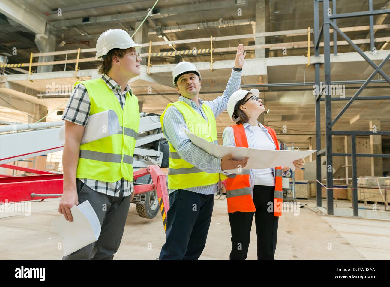 Group of engineers, builders, architects on the building site ...