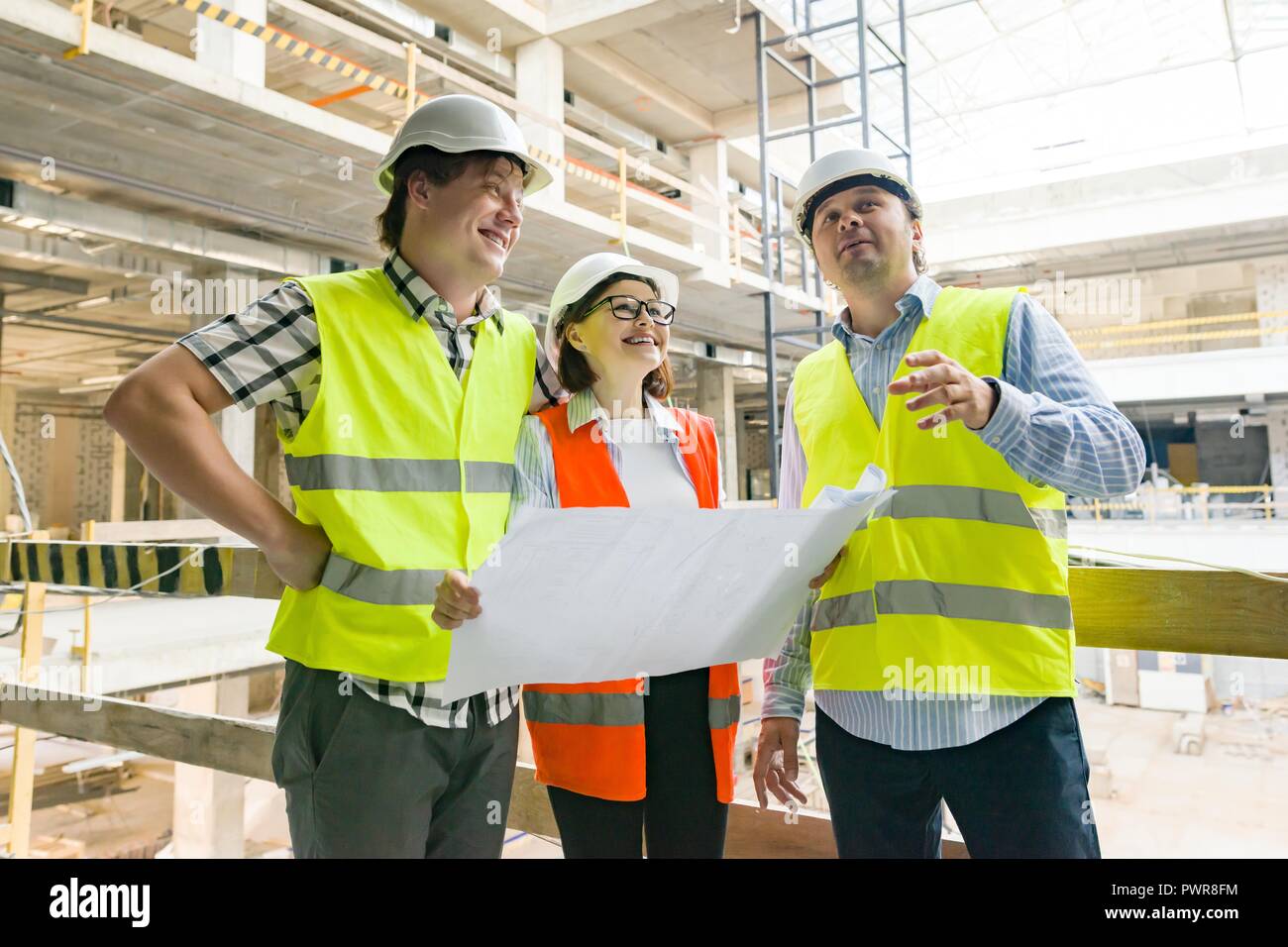 Group of engineers, builders, architects on the building site ...
