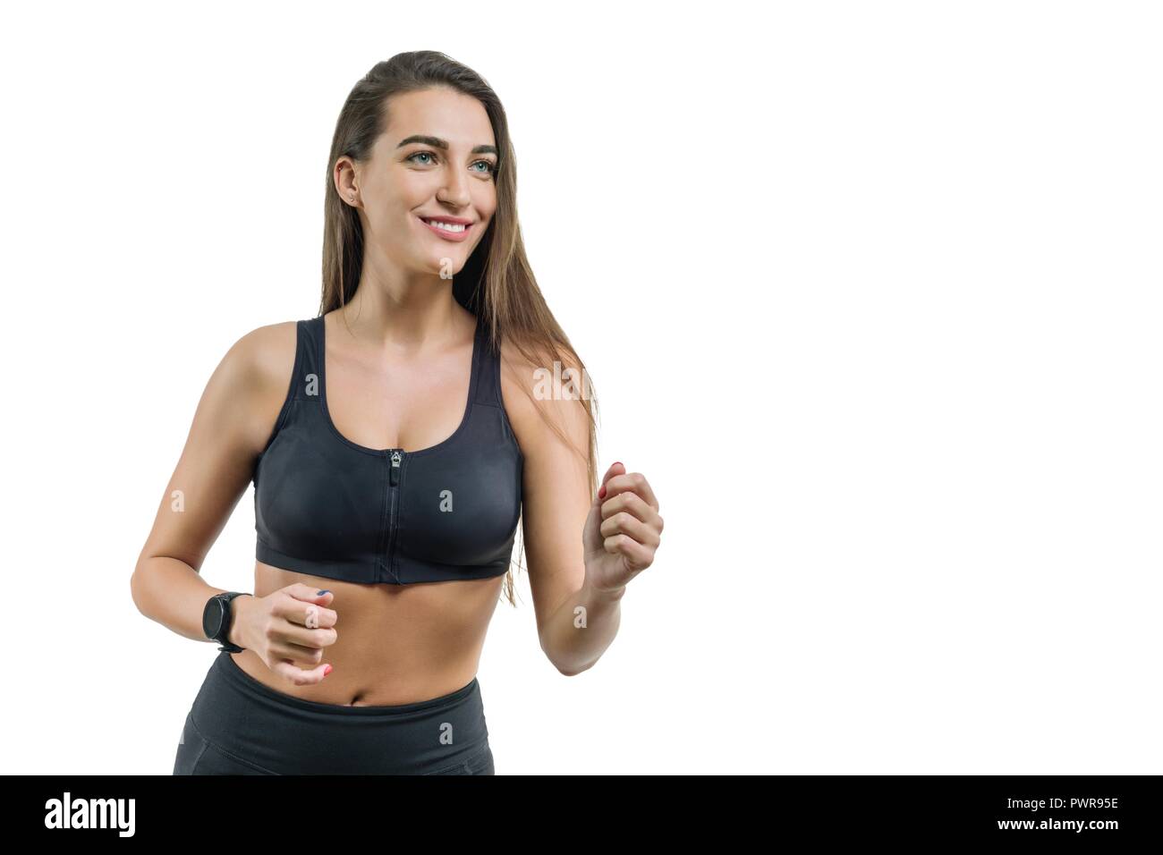 Young woman runner in black sportswear, isolated on white background ...